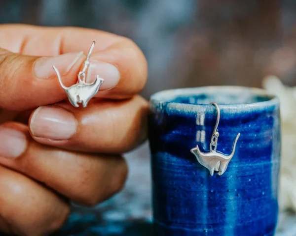 Sitting Silver Cat Earrings, handmade with Sustainable Silver, Hand Shot