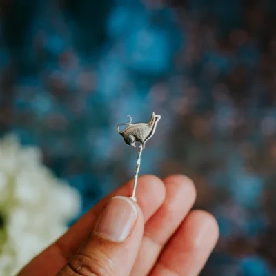 Sitting Silver Cat Pin, handmade with Sustainable Silver, Hand Shot Zoom