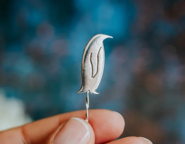 Penguin Pin, handmade with Sustainable Silver, Hand Shot