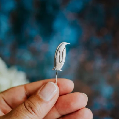 Penguin Pin, handmade with Sustainable Silver, Hand Shot Zoom