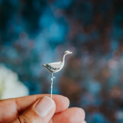 Snow Goose Pin, handmade with Sustainable Silver, Hand Shot Zoom