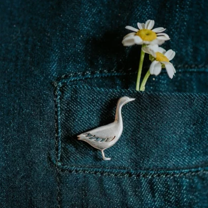 Snow Goose Pin, handmade with Sustainable Silver, Model Shot