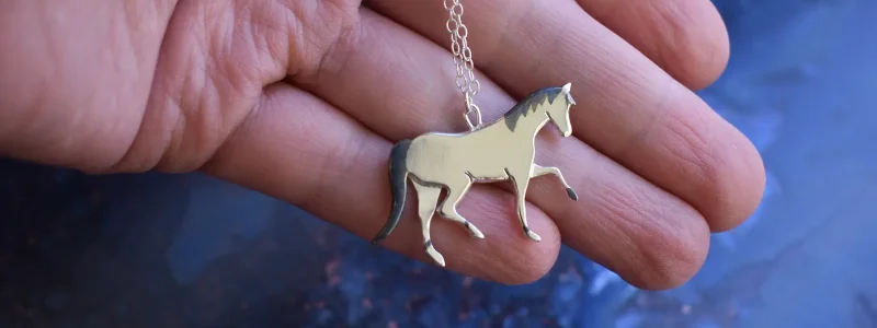 Bespoke pony necklace pierced from 2 sheets of recycled silver, with oxidised detailing